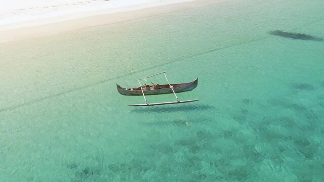 Various shots of isolated traditional outrigger canoes for tourists and local fisherman. Carved from a single piece of wood. Indian Ocean.