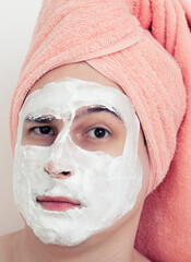Man with a mask on his face. Applying the mask with a brush on the face. Cosmetics for men. Relaxation from cosmetic procedures. Cleaning the face mask.