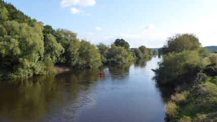 Fototapeta na wymiar Reflection of trees in water along the river Wye.