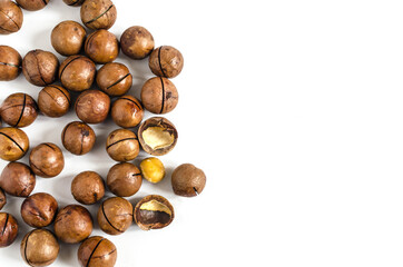 Obraz na płótnie Canvas a scattering of sweet macadamia nuts on a white background kopi space macadamia nut