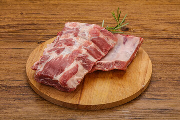 Raw pork ribs served rosemary