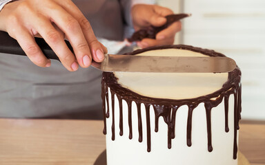 Close up woman is decorating the cake