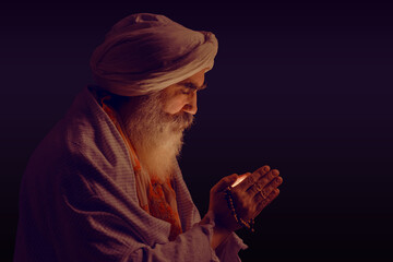 Senior man in a turban is associated with a Hindu, Jain, Buddhist.  Prayer gesture.