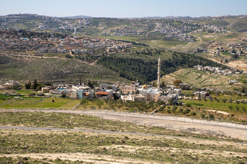 View  from the walls of the ruins of the palace of King Herod - Herodion of the nearby Jewish and Arab settlements in the Judean Desert, in Israel
