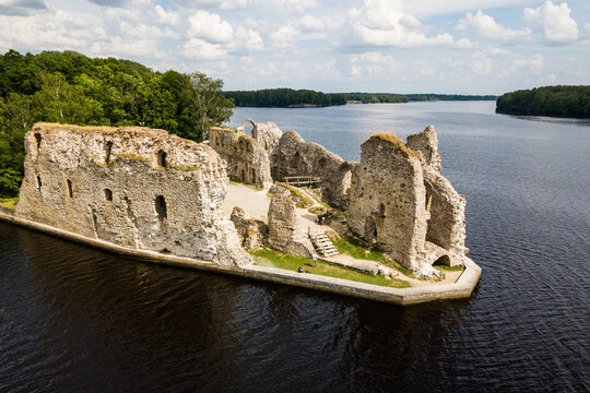 Aerial view of an old stone castle ruins in Koknese, Latvia. Located on a peninsula near the Daugava river and Perse river.