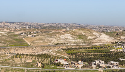 Fototapeta premium View from the walls of the ruins of the palace of King Herod - Herodion of the nearby Jewish and Arab settlements in the Judean Desert, in Israel
