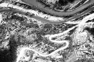 Obraz premium Aerial view on mountain road from drone in winter.