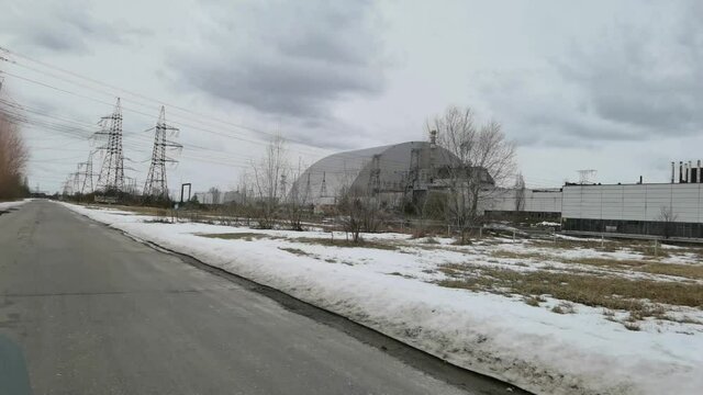 At the Chernobyl Nuclear Power Plant or ChNPP. New Safe Confinement on a background.
