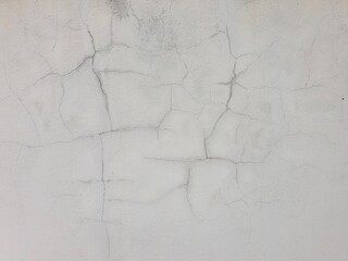 Vintage style smooth cement wall, cracked and black stains.