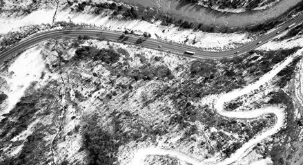 Obraz premium Aerial view on mountain road from drone in winter.
