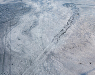 Frosty pattern on ice. Aerial drone top view. Sunny winter day.