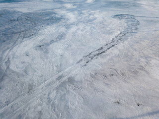 Frosty pattern on ice. Aerial drone top view. Sunny winter day.