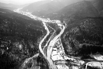 Aerial view on mountain road from drone in winter.