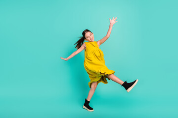 Full size profile photo of optimistic nice brown hair girl dance wear yellow dress isolated on bright teal color background