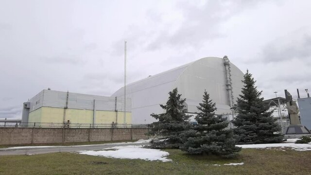 At the Chernobyl Nuclear Power Plant or ChNPP. New Safe Confinement on a background.