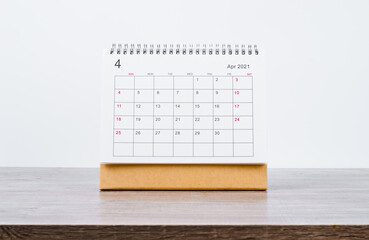 April Calendar 2021 on wooden table.