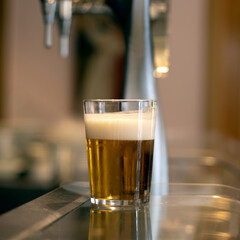 Glass of beer on a bar counter.