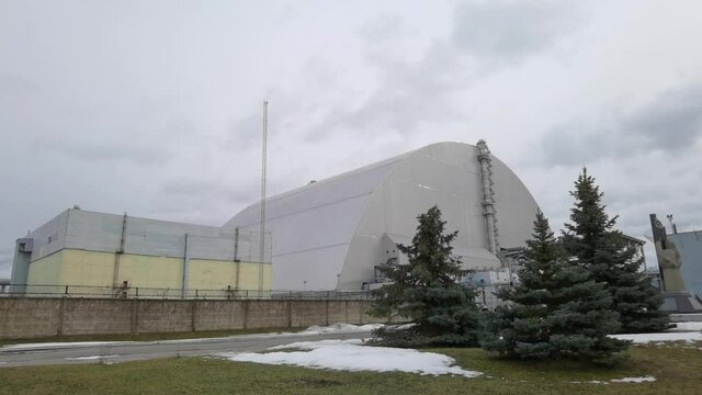 At the Chernobyl Nuclear Power Plant or ChNPP. New Safe Confinement on a background.