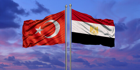 Turkey and Egypt flag waving in the wind against white cloudy blue sky together. Diplomacy concept,...