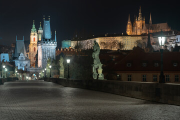 street lamp of Charles Bridge at night and Prague Castle in the background