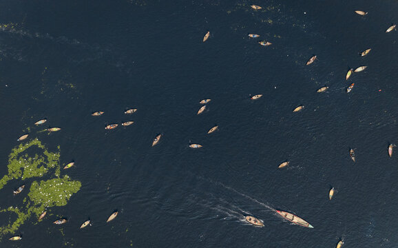 Aerial view of colourful ferry boat docket at small wharf along Buriganga river in Keraniganj, Dhaka, Bangladesh.