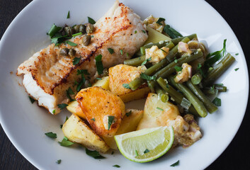 Baked white cod fish, bacalhau, with roasted potatoes and simple skillet green beans