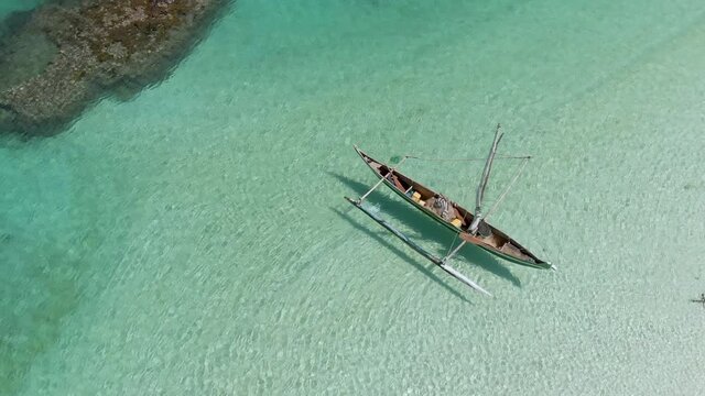 Various shots of isolated traditional outrigger canoes for tourists and local fisherman. Carved from a single piece of wood. Indian Ocean.