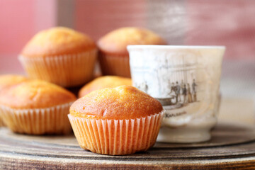 Delicious fresh muffins with berry filling and a cup of coffee