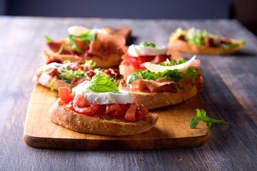 Hamburger, french fries, dip. Food on a black background.