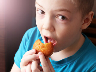 Little boy eats a delicious muffin