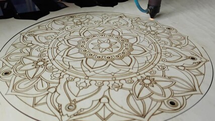 modern industrial equipment. Laser cutting on wood. The laser beam passes through the plywood, cuts out a drawing or pattern. processing wooden products. Modern technologies in woodworking