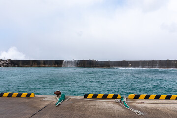 Rough waves over the breakwater