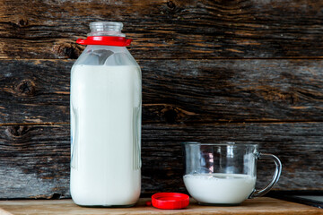 Bottle with organic milk  in kitchen with rustic looking  background