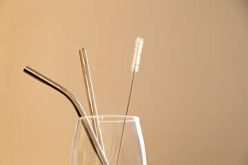 Glass cup with ecological straw on the kitchen counter. With copy space. Ecology concept. Reuse concept.
