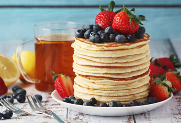 A stack if home-made pancakes with berry