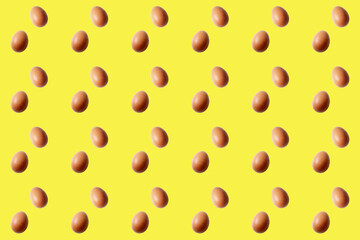 Fototapeta na wymiar brown egg pattern on yellow background