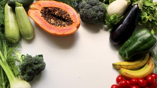 Male hand takes red pepper on healthy food clean eating selection: fruit, vegetable, avocado, papaya, pumpukin superfood, leaf vegetable