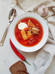 Borscht with meat on a white plate