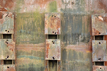 Old Rusty Metal Green Background. Damaged Aged Box With Rust And Peeled Paint. Eroded And Corroded Cargo Container Wall. Weathered Industrial Bg.