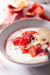 Fresh healthy breakfast greek yogurt with blood oranges, cashew butter and chia seeds
