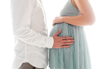 Cropped view of man in white shier touching belly of pregnant wife isolated on white