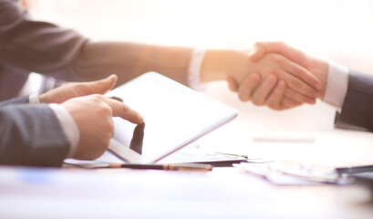 businessman with a digital tablet sitting at the meeting table .
