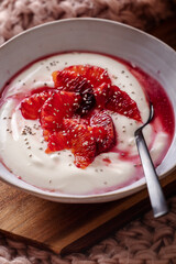 Fresh healthy breakfast greek yogurt with blood oranges, cashew butter and chia seeds