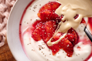 Fresh healthy breakfast greek yogurt with blood oranges, cashew butter and chia seeds