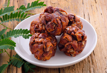 Tamarind, a naturally sourced food ingredient on a wooden table.