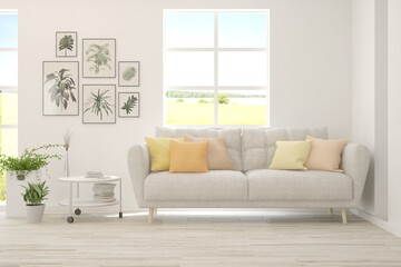 White living room with sofa and summer landscape in window. Scandinavian interior design. 3D illustration