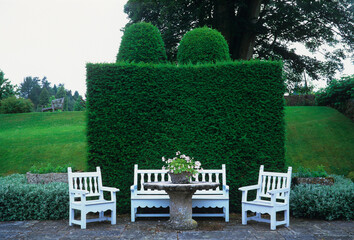 Ornamental garden seats in a terrace of a country garden