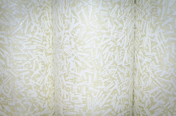 Cream wallpaper rolls for room renovation.