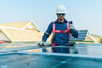 A technician action thump up during installing the solar panels at roof top of home and home office ,concept of economic energy and cost saving ,own small business,own business concept