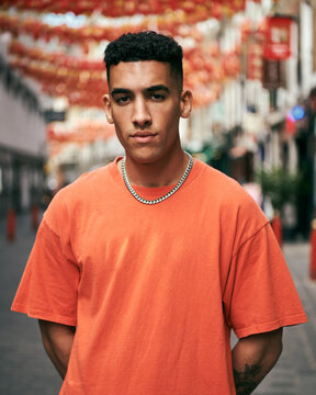 Portrait Of A Man In A Orange Tee Shirt In China Town